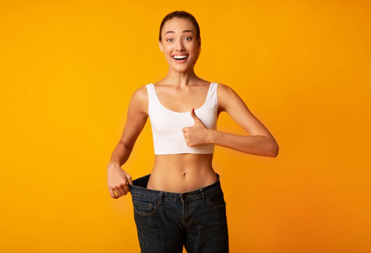 Woman in pants at the ideal weight for liposuction.