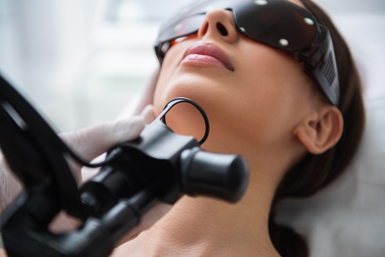 woman in chair with glasses about to undergo laser skin